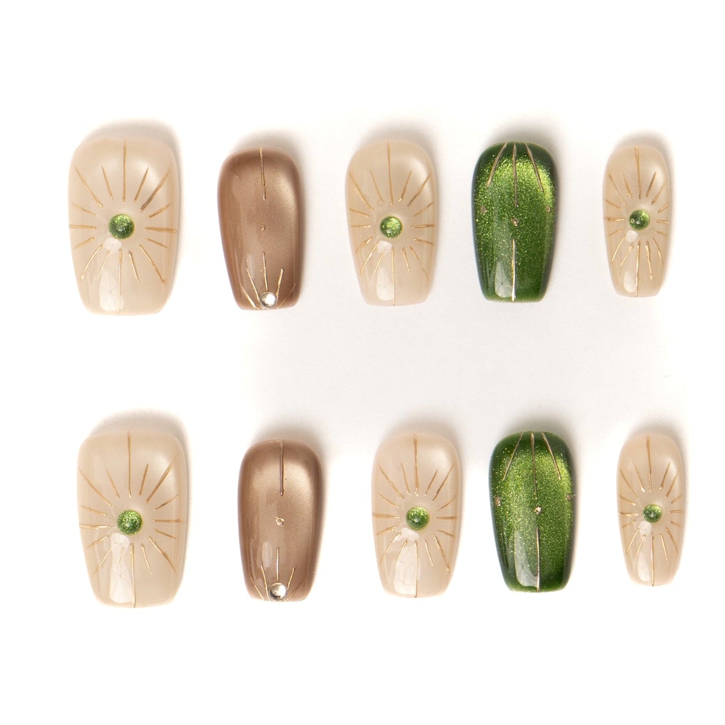 Flat lay of ten press-on nails arranged in two neat rows on a white background, featuring a neutral palette of cream, taupe, and deep green. The designs include subtle gold sunburst line art and small green gemstone accents, with a mix of glossy solid and softly shimmering finishes.