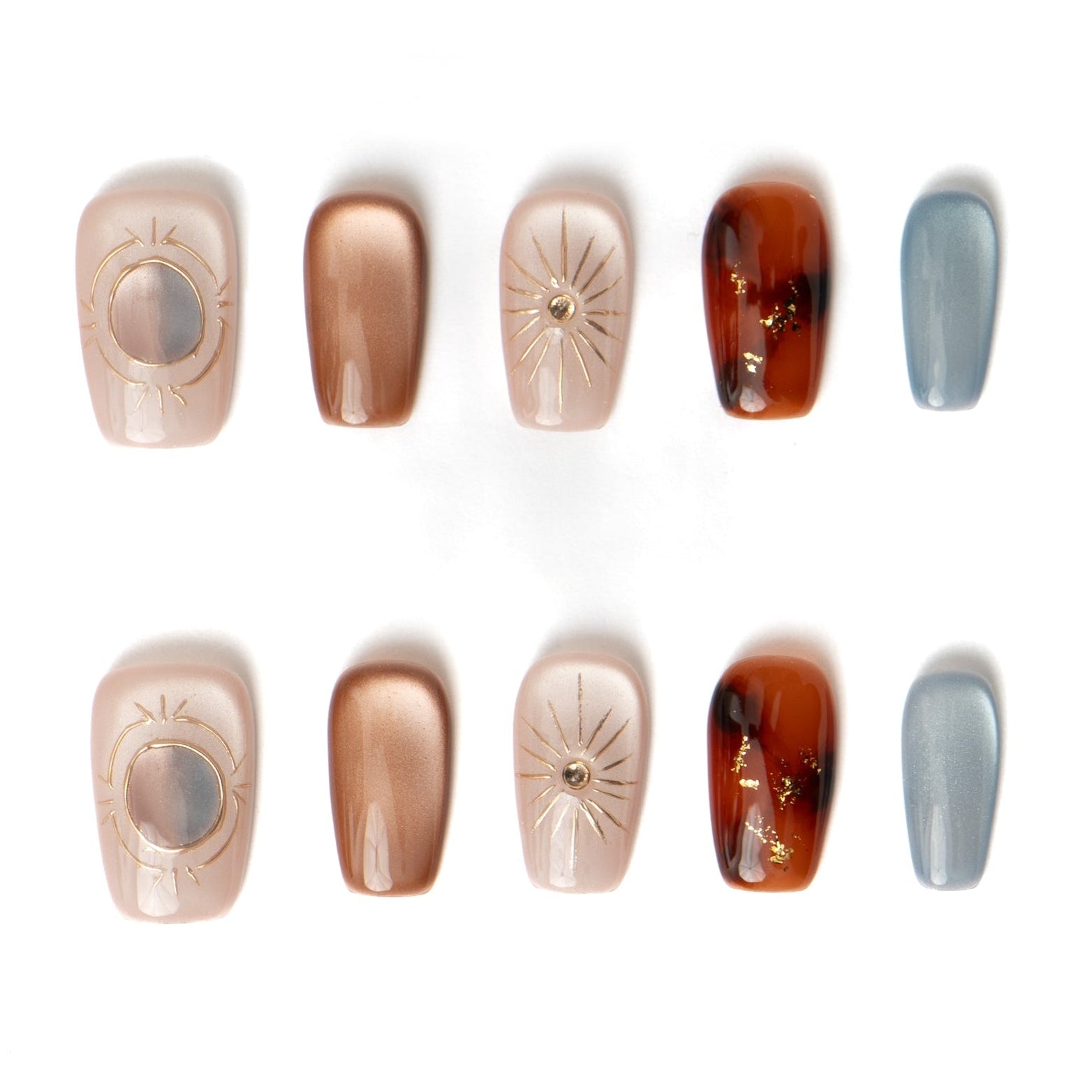 Full set of boho style press-on nails showing individual designs: amber tortoise, bronze shimmer, and hand-painted gold suns.