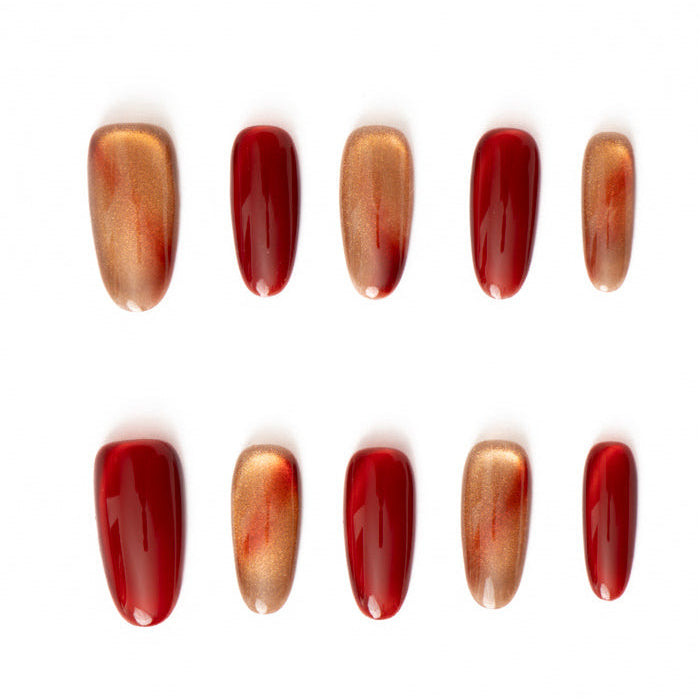 Flat lay of ten press-on nails arranged in two rows on a white background, featuring a bold red and warm bronze color palette. The set alternates between glossy crimson nails and metallic bronze cat-eye finishes with subtle gradient shimmer for a rich, fiery, and elegant look.