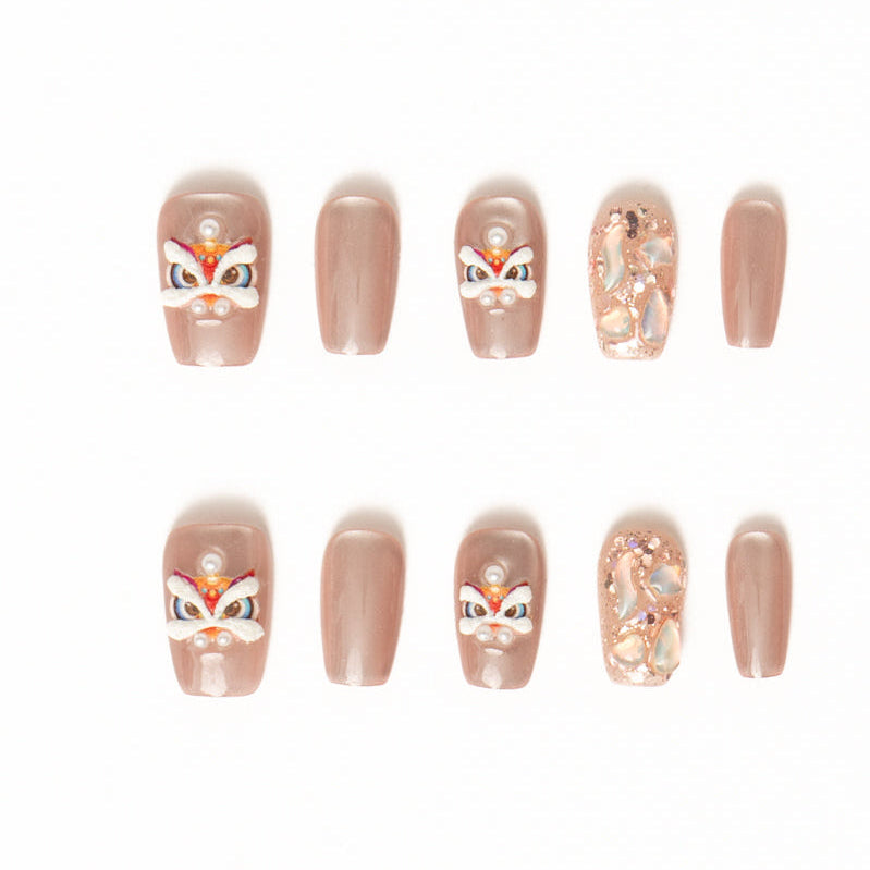 Flat lay of ten press-on nails arranged in two rows on a white background, featuring a soft nude-beige palette. The set includes glossy solid nude nails, accent nails with delicate pearl details, abstract iridescent shell textures, and playful hand-painted mask-inspired designs with white, red, and gold accents for an elegant yet whimsical look. Lunar New year nails