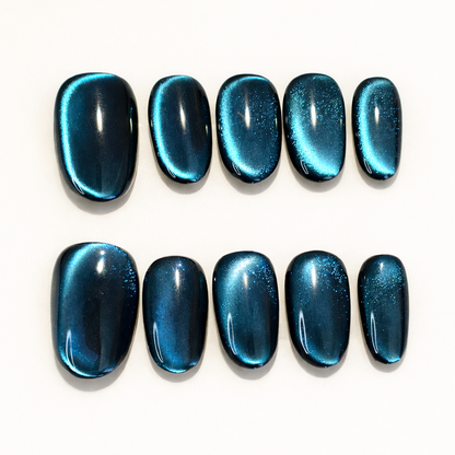 oval shape high quality Full set of dark petrol blue velvet cat eye press-on nails, showing the magnetic shimmer and glossy top coat.