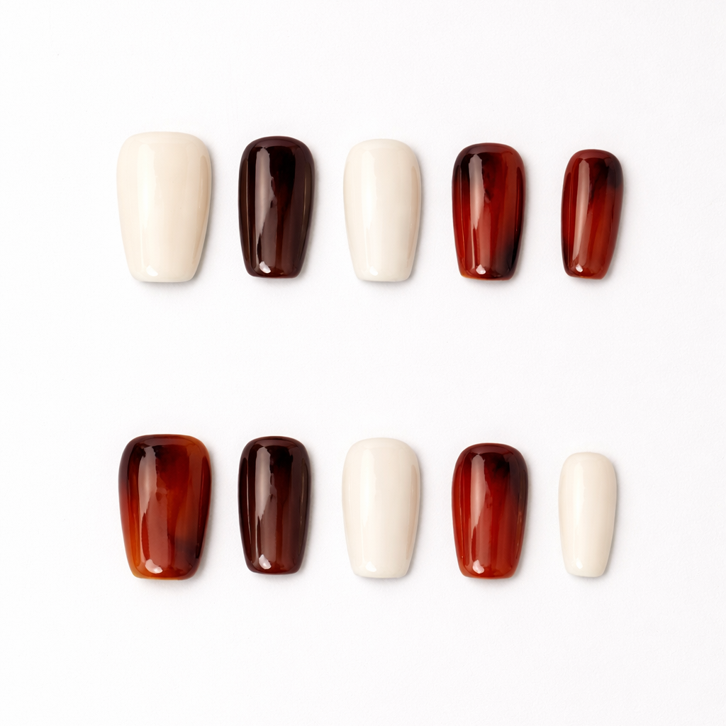 Lumi Loop handmade press-on nails flat lay featuring a chic mix of dark amber tortoise shell pattern and solid glossy cream beige. Classic square shape.